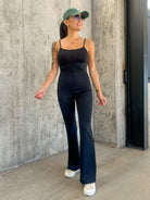 Women's black buttery soft stretchy athletic jumpsuit with adjustable straps