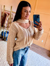 chunky sweater with cut out neck and pom pom detail