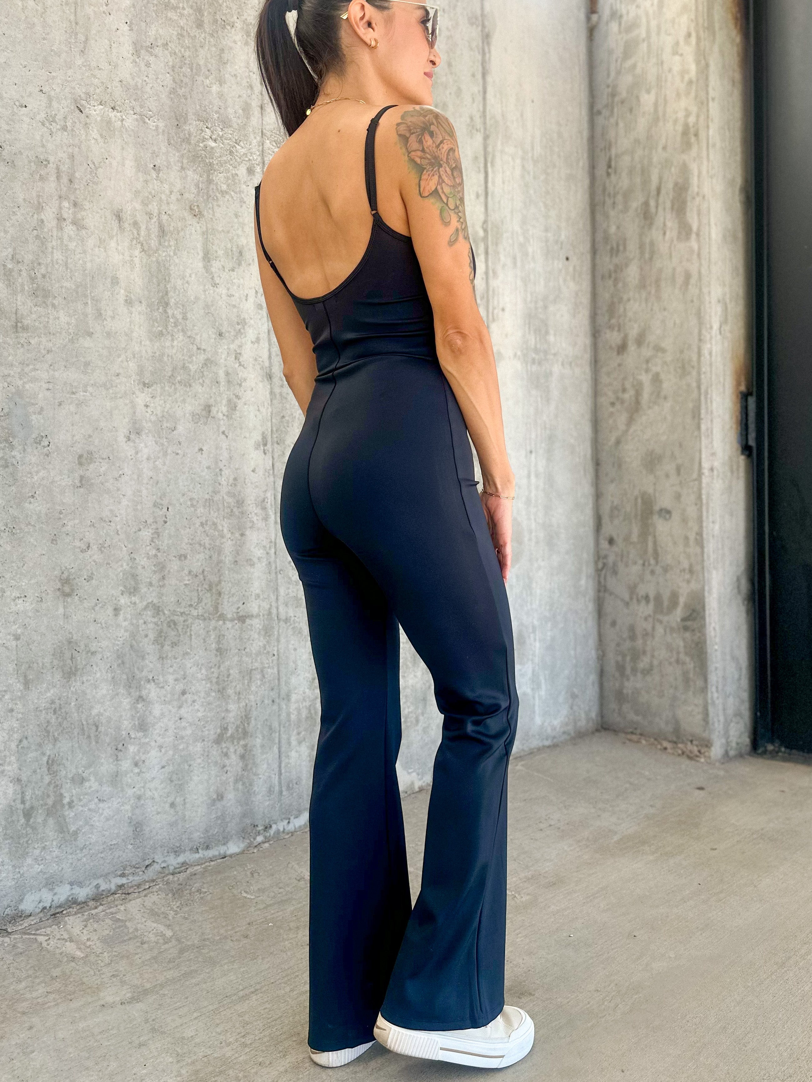 Women's black buttery soft stretchy athletic jumpsuit with adjustable straps